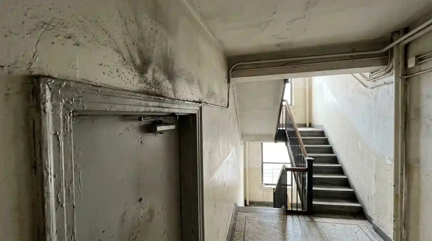 Light soot staining around an apartment door frame from a nearby fire